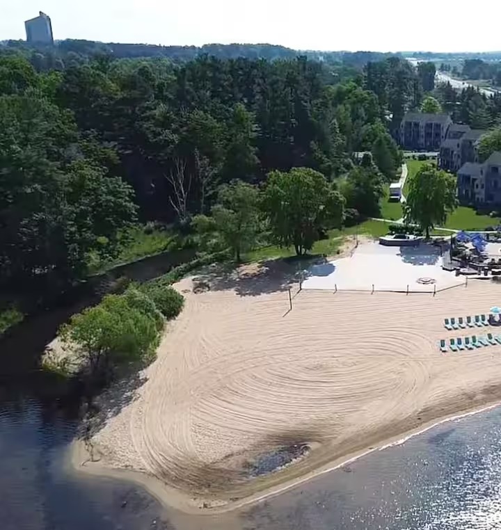 Aerial view of the shared sandy beach on East Grand Traverse Bay